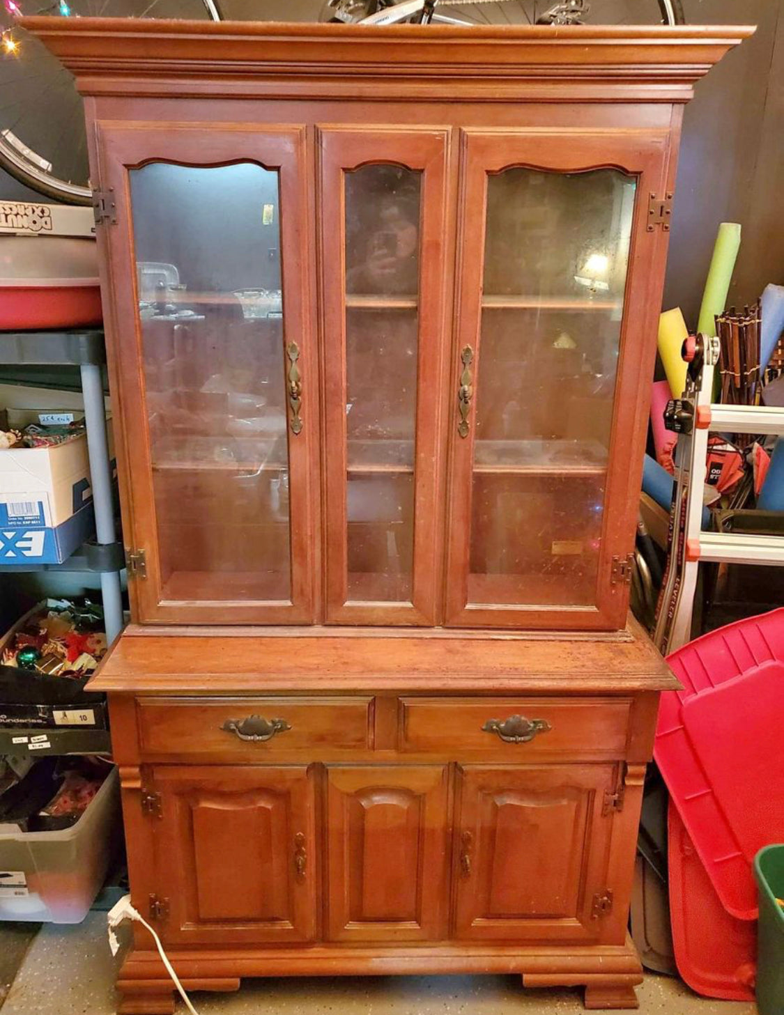 China hutch with glass shelves and overhead light